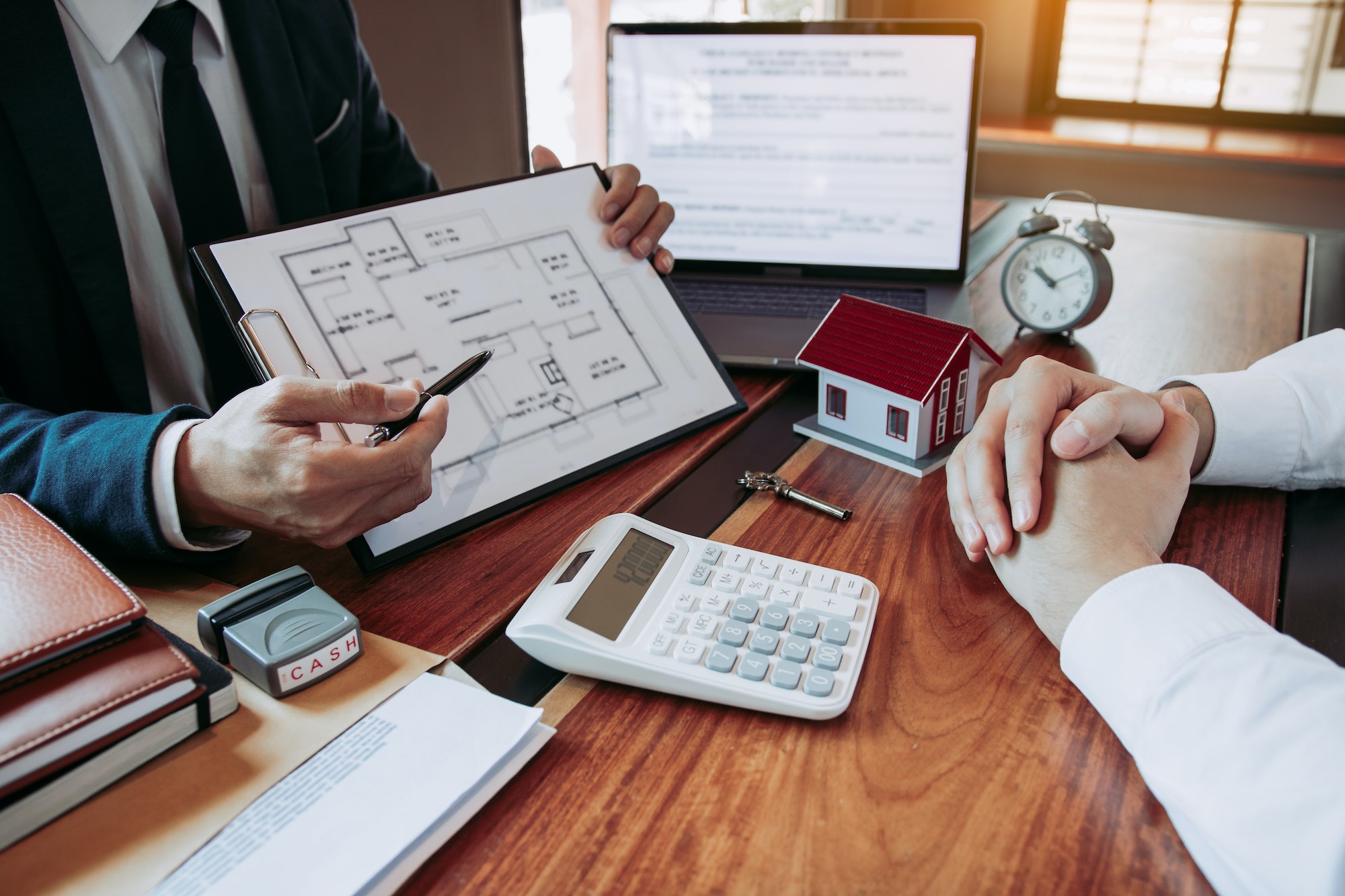 Agents are using pens pointing to blueprint home design