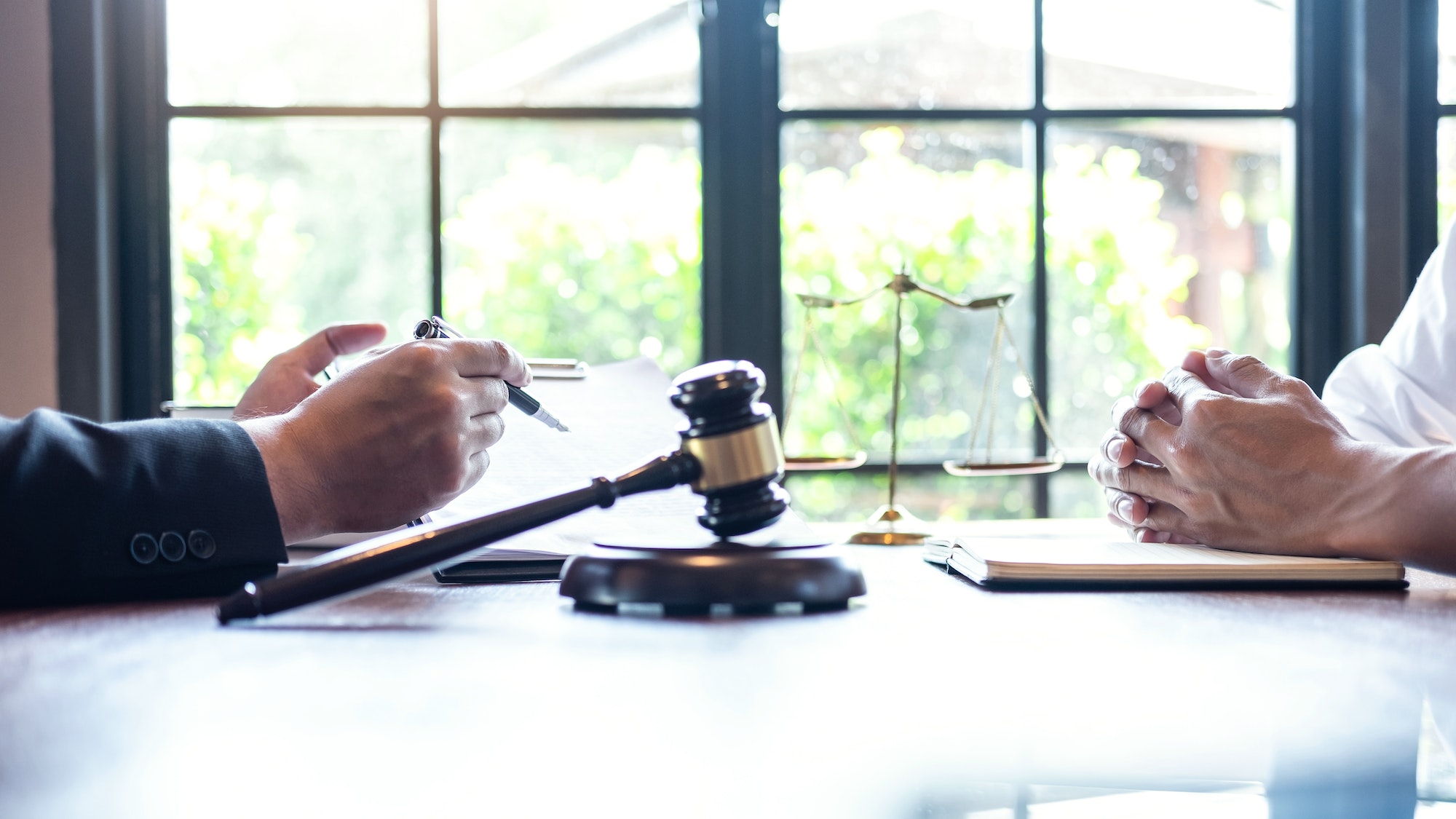 Professional male lawyer or counselor discussing negotiation legal case with client meeting with